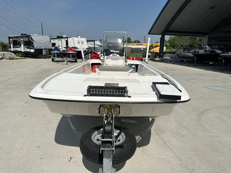 Slide: The Image of 2018 Mako 17 Pro Skiff boat on trailer in outdoor storage area. - 10