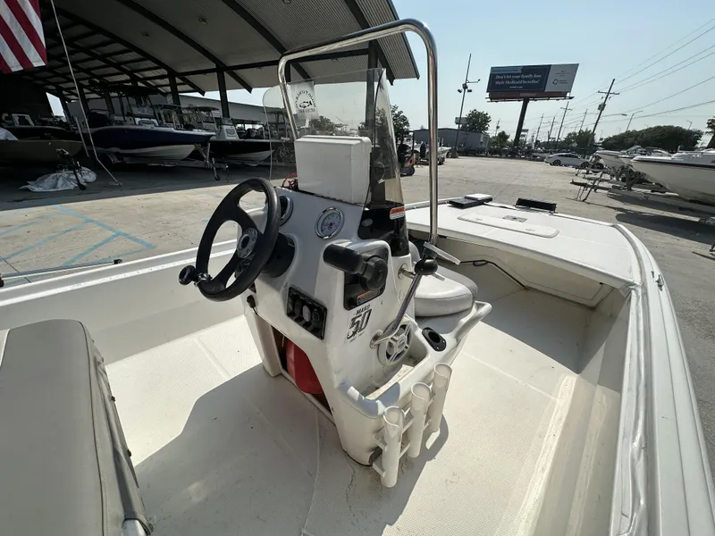 Slide: The Image of 2018 Mako 17 Pro Skiff boat interior with steering console and seating. - 11