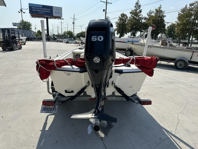 Slide: The Image of 2018 Mako 17 Pro Skiff with 60 HP outboard motor on trailer. - 6