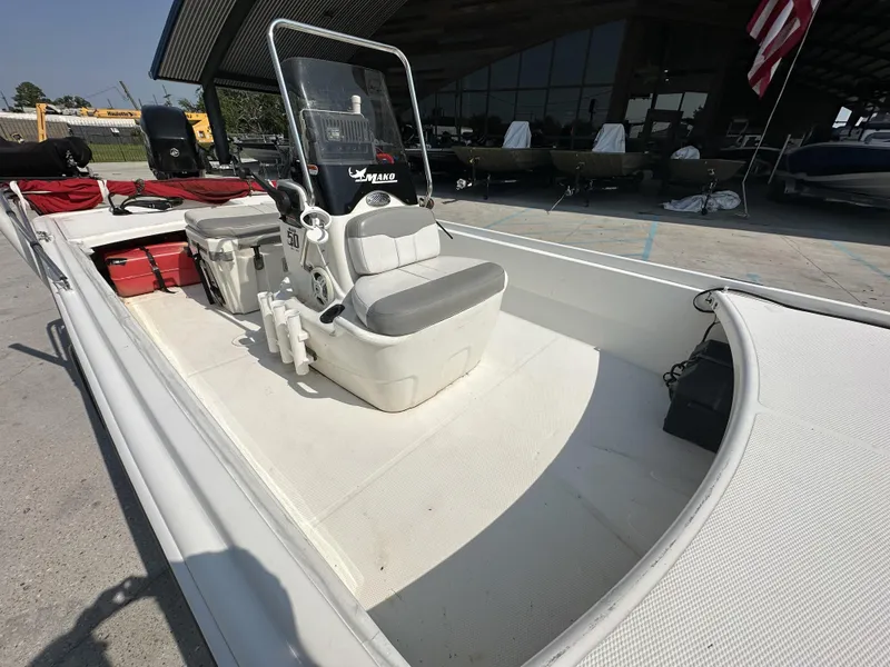 Slide: The Image of 2018 Mako 17 Pro Skiff boat interior with seating and storage compartments. - 7
