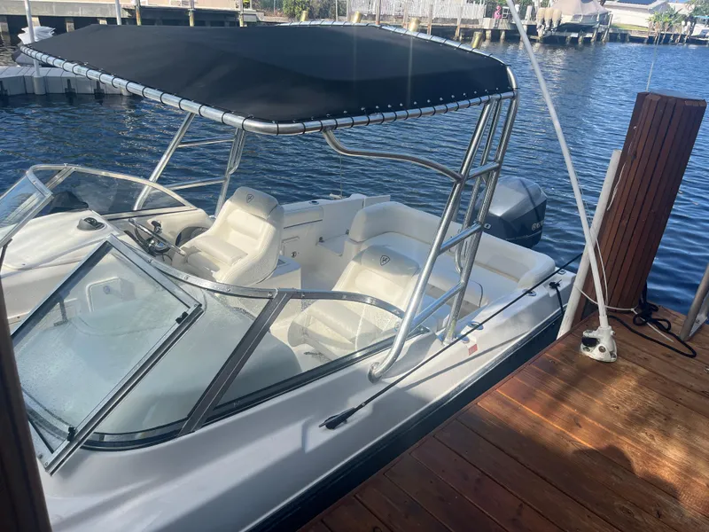 Slide: The Image of 2008 Century 2350 Dual Console boat docked by the water. - 10