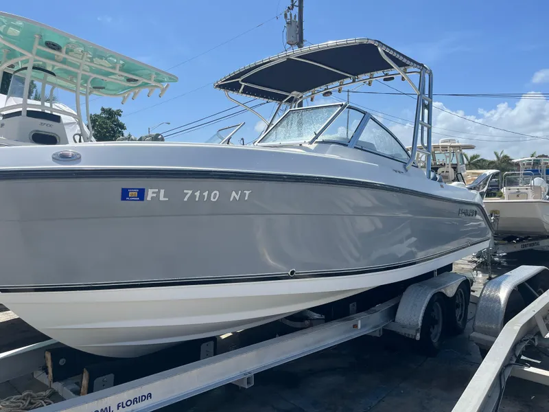 Slide: The Image of 2008 Century 2350 Dual Console boat on trailer, sunny day, Florida registration visible. - 11