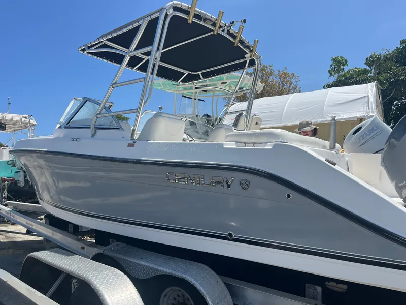 Slide: The Image of 2008 Century 2350 Dual Console boat on trailer, side view under clear blue sky. - 12