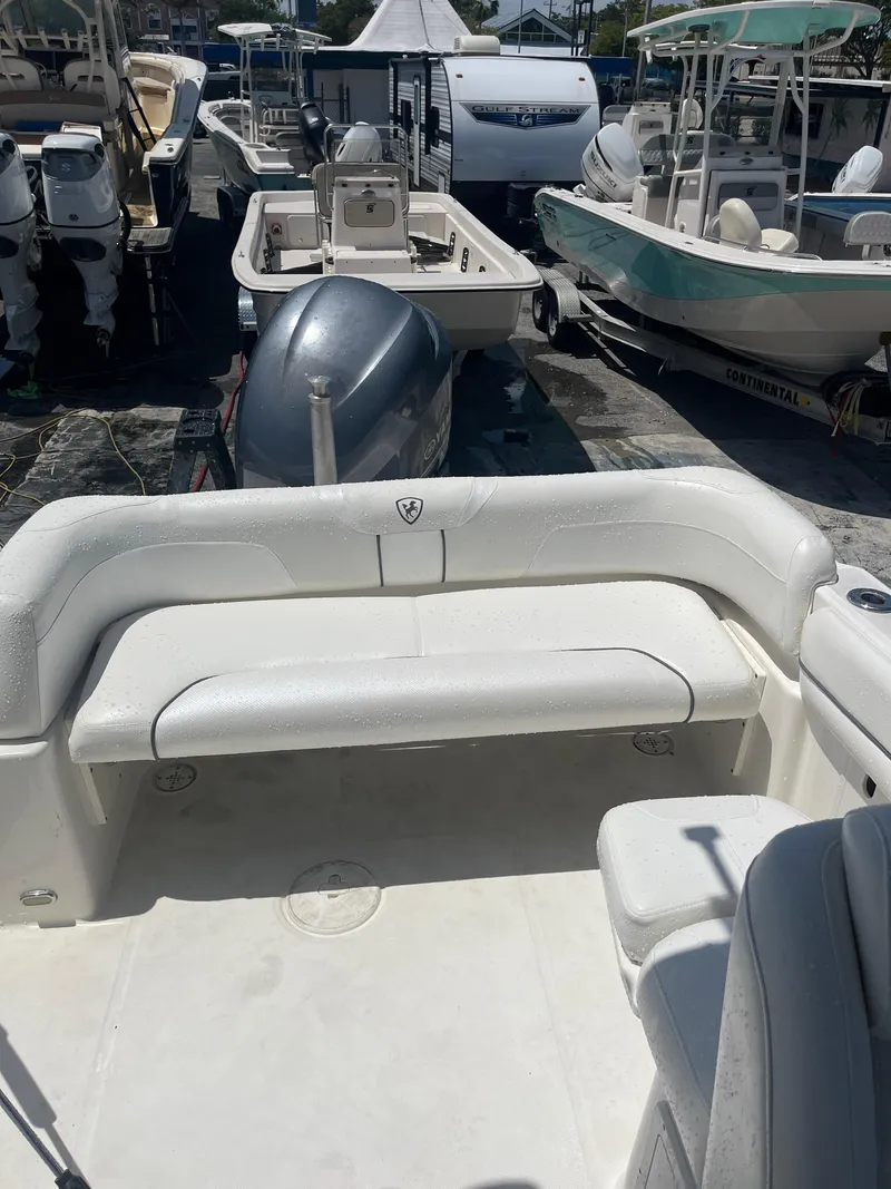 Slide: The Image of 2008 Century 2350 Dual Console boat with spacious seating, docked among other boats. - 14