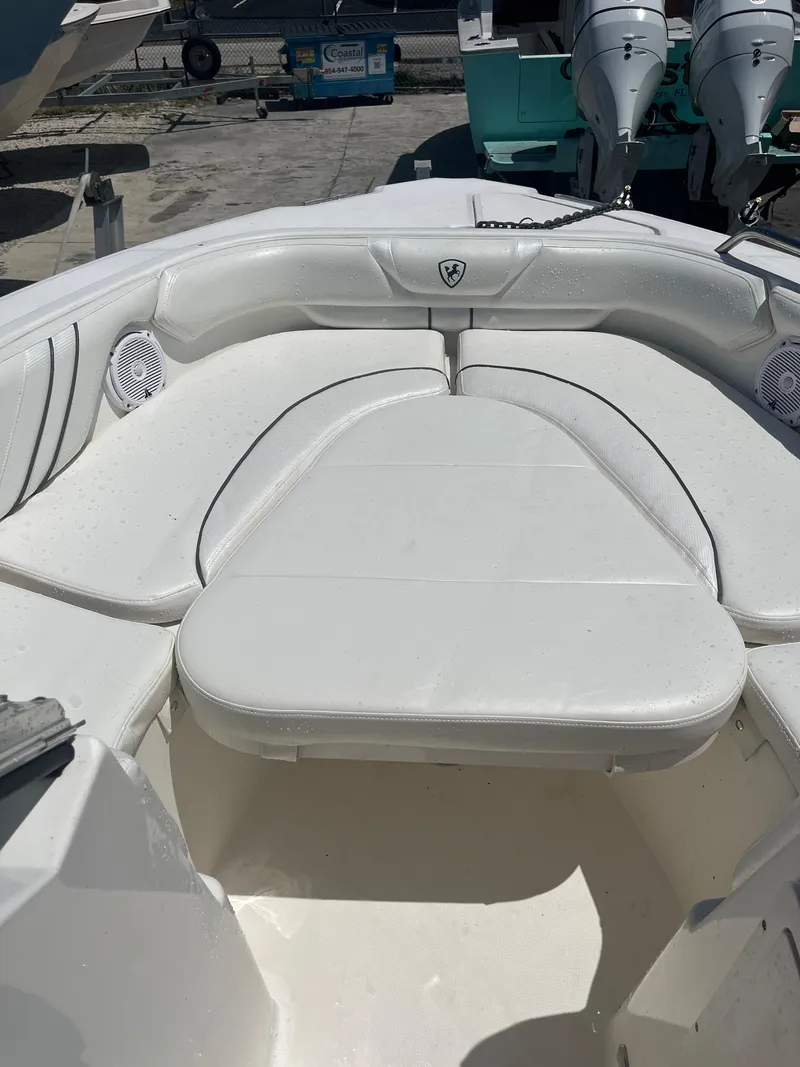 Slide: The Image of 2008 Century 2350 Dual Console boat with white cushioned seating in the bow area. - 15