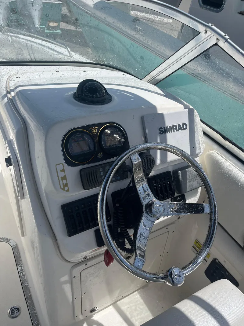 Slide: The Image of 2008 Century 2350 Dual Console boat dashboard with steering wheel and Simrad display. - 18