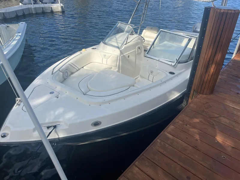 Slide: The Image of 2008 Century 2350 Dual Console boat docked on calm water. - 8