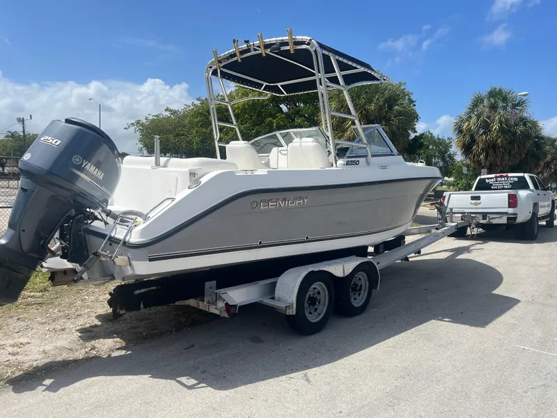 Slide: The Image of 2008 Century 2350 Dual Console boat on trailer with Yamaha engine, parked outdoors. - 9
