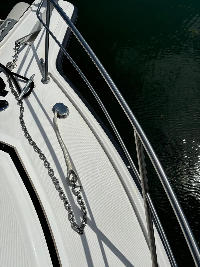 Slide: The Image of 1989 Phoenix 33 Sportfish boat deck with anchor chain and railing. - 18