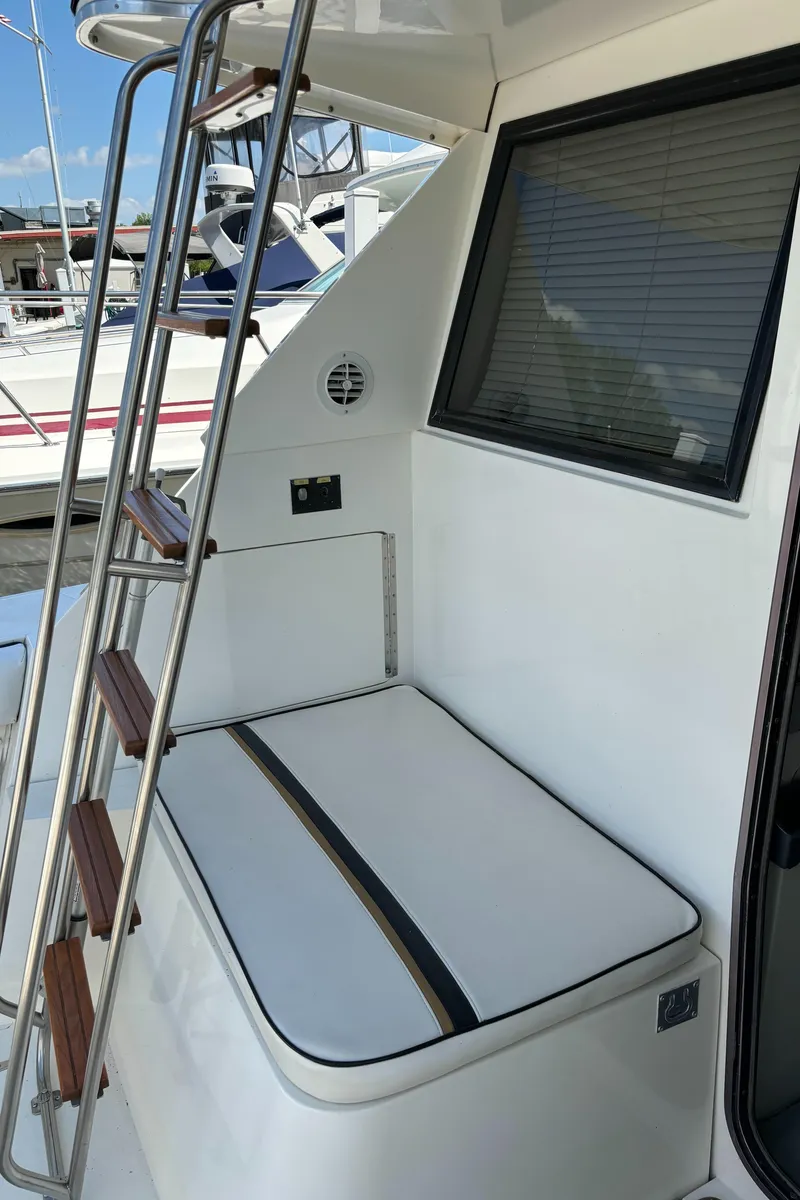 Slide: The Image of 1989 Phoenix 33 Sportfish boat with cushioned seating and ladder on deck. - 26