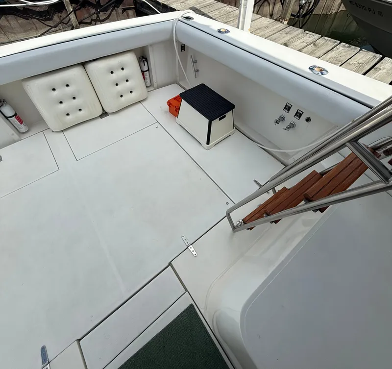 Slide: The Image of 1989 Phoenix 33 SFX boat deck with seating, steps, and storage compartments. - 27
