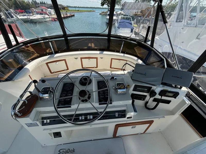 Slide: The Image of Cockpit of 1989 Phoenix 33 Sportfish boat with steering wheel and navigation equipment. - 31
