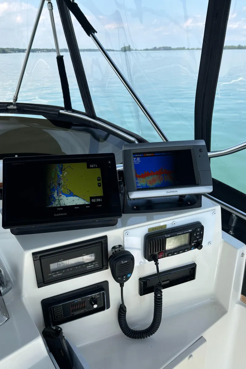Slide: The Image of Dashboard of a 1989 Phoenix 33 Sportfish boat with navigation equipment. - 32