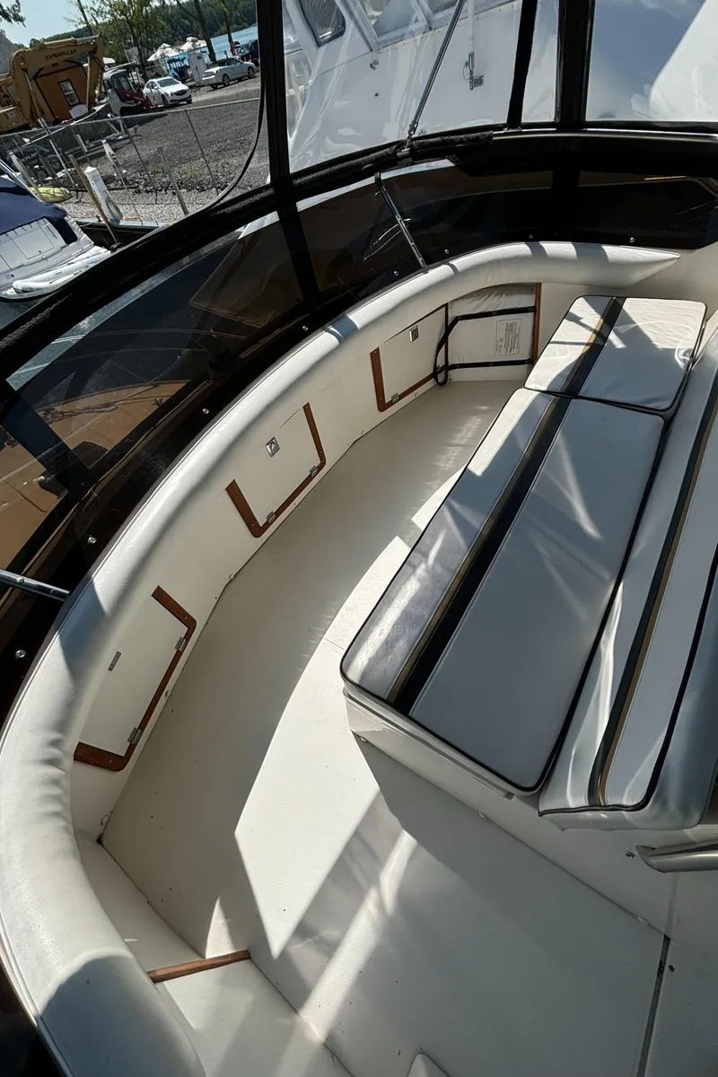 Slide: The Image of 1989 Phoenix 33 Sportfish boat interior with cushioned seating and sleek design. - 35