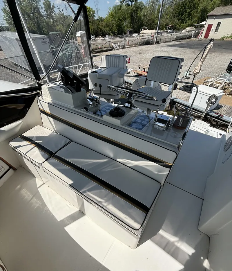 Slide: The Image of 1989 Phoenix 33 Sportfish boat interior with seating and control panel. - 36