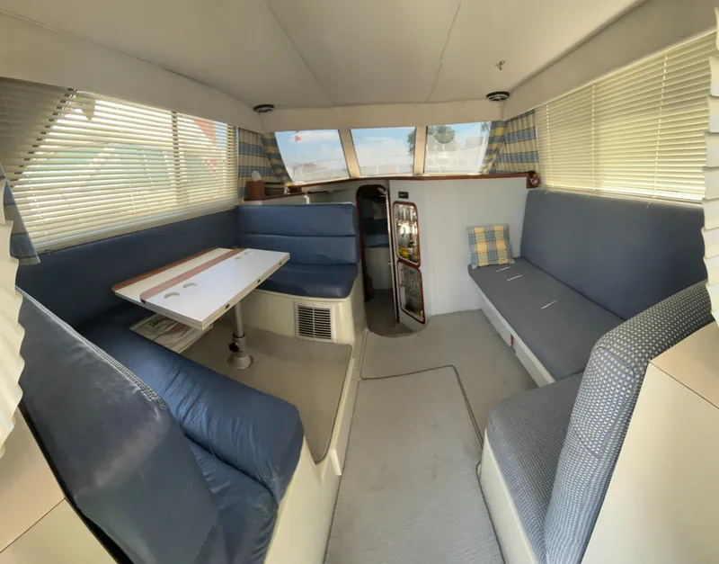 Slide: The Image of Interior of 1989 Phoenix 33 Sportfish boat with blue seating and dining table. - 37