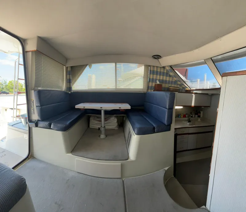 Slide: The Image of Interior of 1989 Phoenix 33 Sportfish boat with blue seating and dining area. - 38