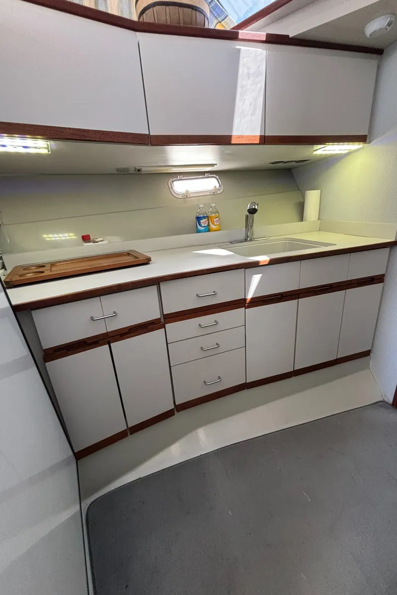 Slide: The Image of 1989 Phoenix 33 Sportfish yacht kitchen with modern cabinetry and countertop. - 45