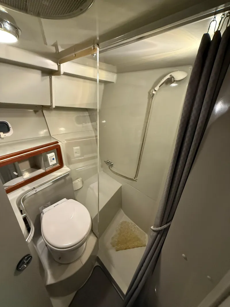 Slide: The Image of 1989 Phoenix 33 Sportfish bathroom with shower, toilet, and storage. - 49
