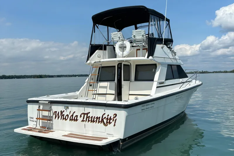 Slide: The Image of 1989 Phoenix 33 Sportfish boat on water, named "Who'da Thunkit," with clear skies. - 5