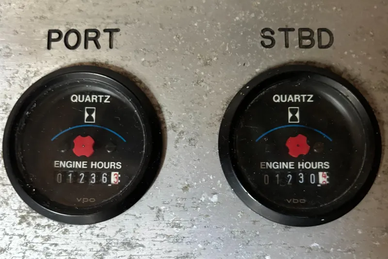 Slide: The Image of Engine hour meters on 1989 Phoenix 33 Sportfish boat dashboard, showing port and starboard readings. - 52