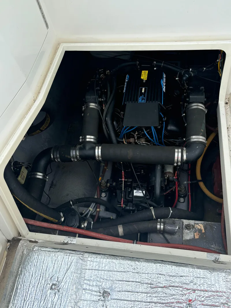 Slide: The Image of Engine compartment of a 1989 Phoenix 33 Sportfish boat, showcasing mechanical components. - 53
