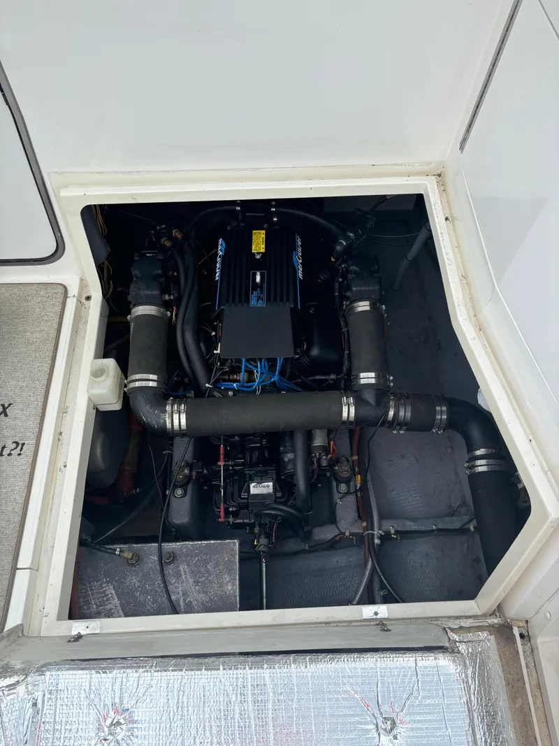 Slide: The Image of Engine compartment of a 1989 Phoenix 33 Sportfish boat, showcasing detailed mechanical components. - 54