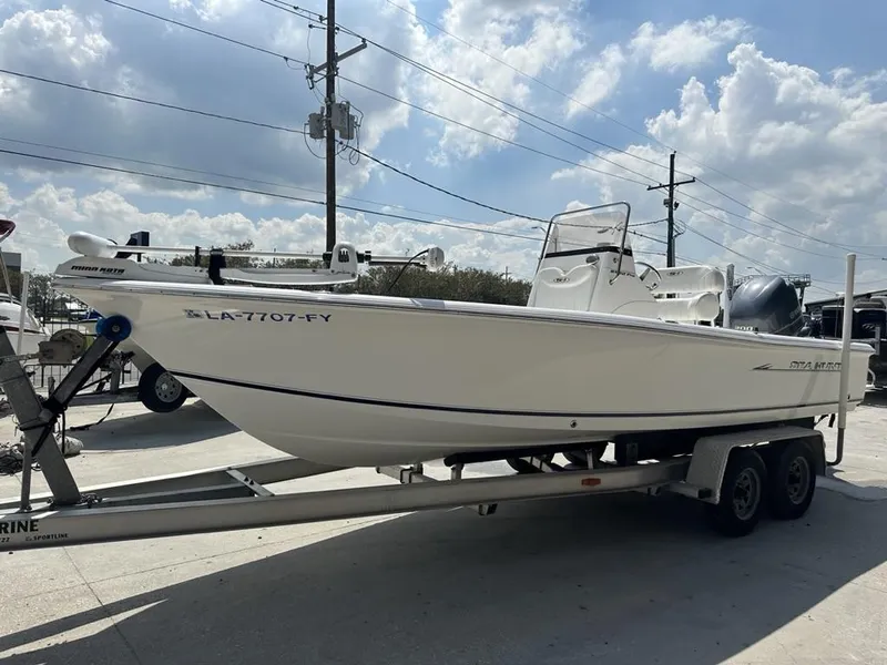 Slide: The Image of 2012 Sea Hunt BX 22 Pro boat on trailer under cloudy sky. - 2