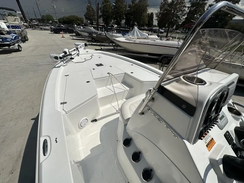 Slide: The Image of 2012 Sea Hunt BX 22 Pro boat, white interior, docked outdoors, clear console view. - 6