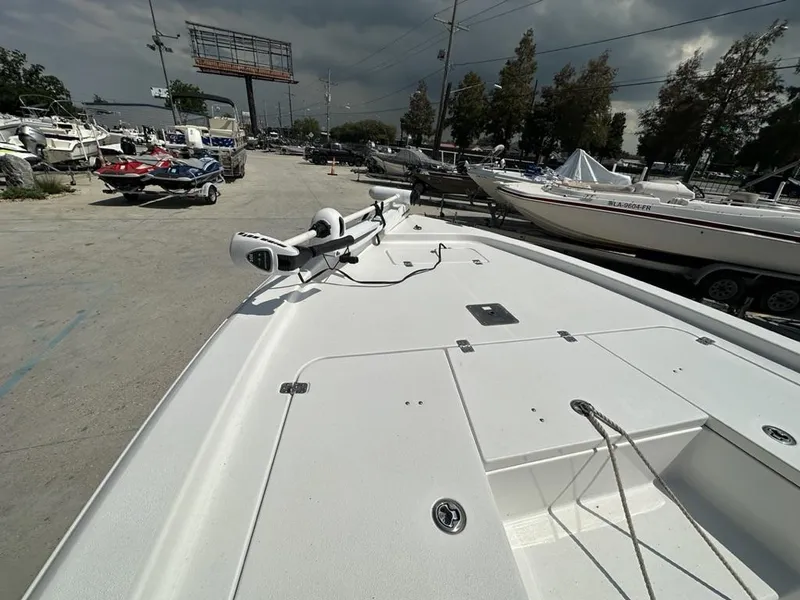 Slide: The Image of 2012 Sea Hunt BX 22 Pro boat on trailer, surrounded by other boats under cloudy sky. - 7