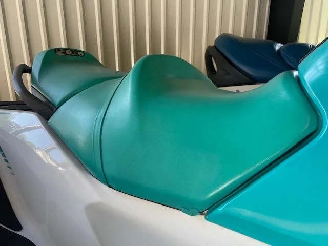 Slide: The Image of 2021 Sea-Doo GTX Pro jet ski with teal seat, parked indoors. - 7