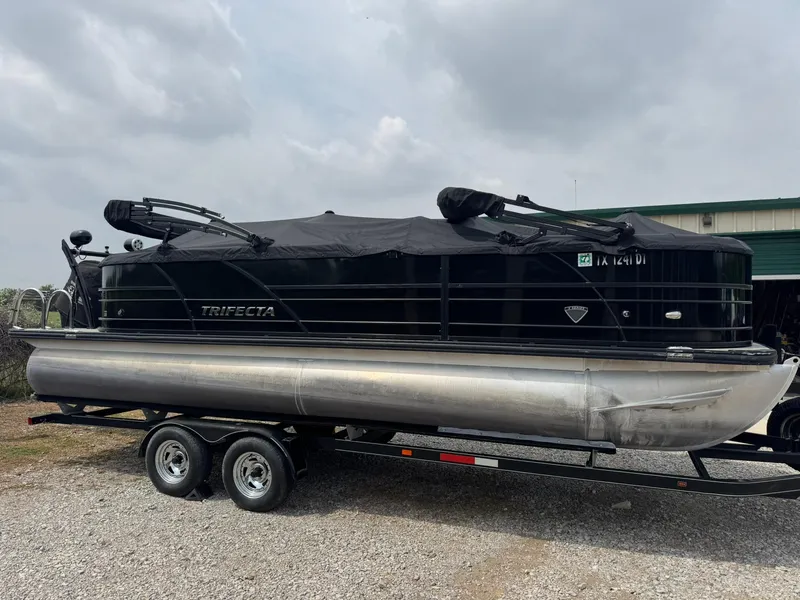 Slide: The Image of 2017 Trifecta SS 23RF pontoon boat on trailer, covered and parked outdoors. - 10
