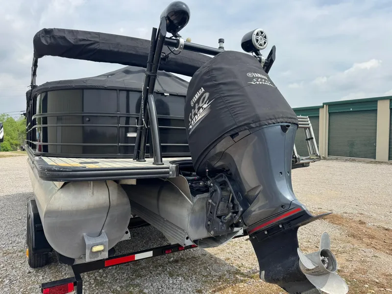 Slide: The Image of 2017 Trifecta SS 23RF pontoon boat with Yamaha outboard motor, parked on a trailer. - 12