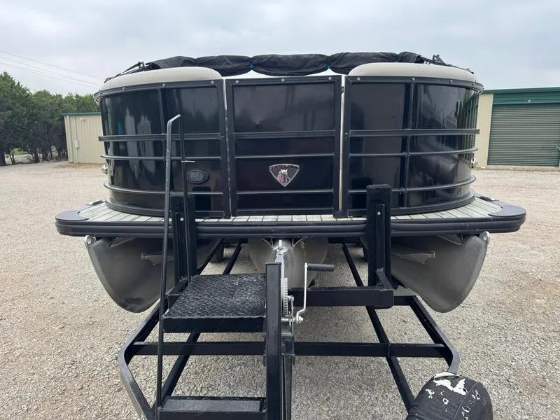 Slide: The Image of 2017 Trifecta SS 23RF pontoon boat on trailer, front view, parked outdoors. - 2
