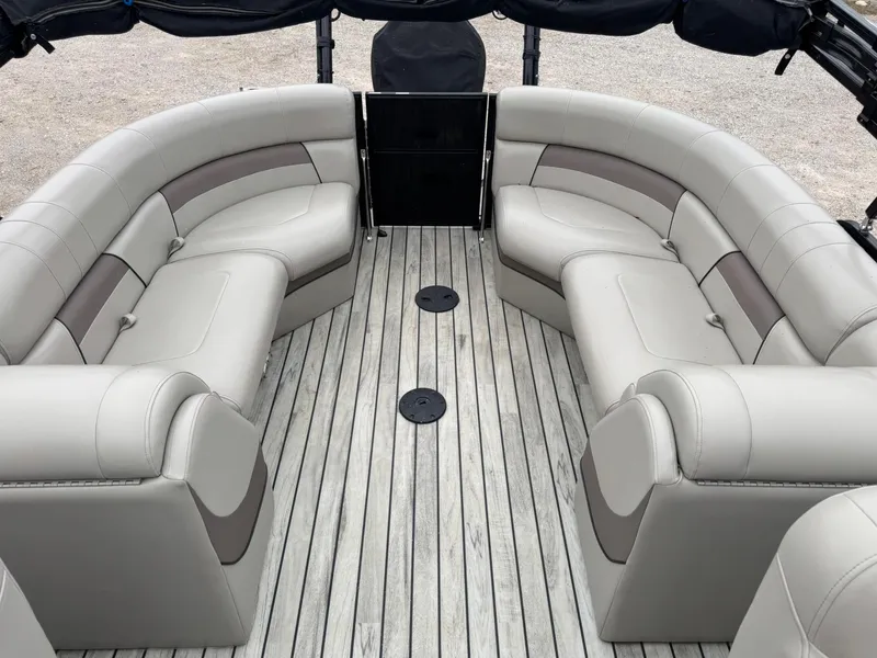 Slide: The Image of 2017 Trifecta SS 23RF pontoon boat interior with gray seating and wooden deck. - 7