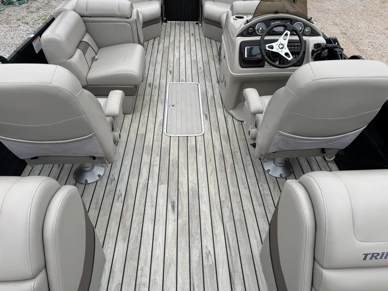 Slide: The Image of 2017 Trifecta SS 23RF boat interior with gray seating and wood-style flooring. - 8