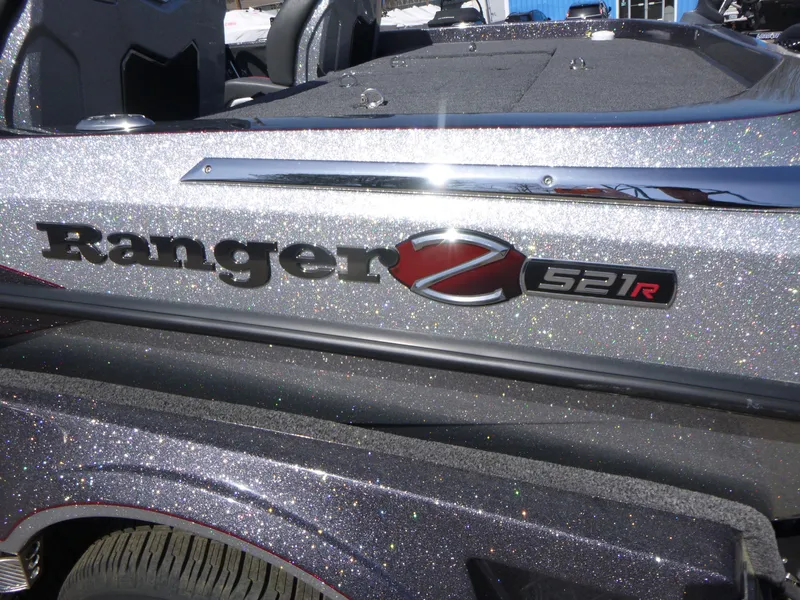 Slide: The Image of 2024 Ranger Z521R boat with metallic finish and logo detail. - 5