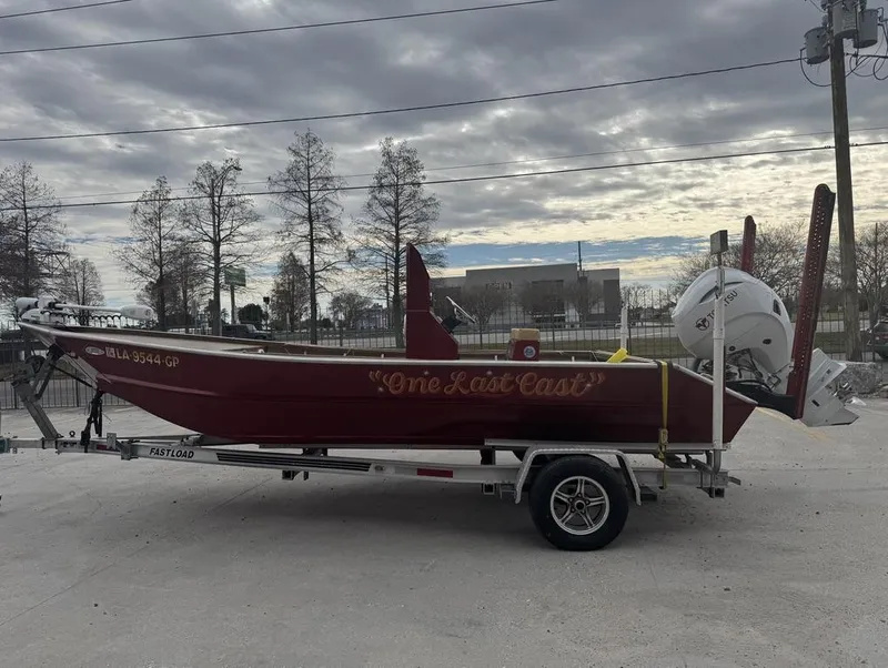 Slide: The Image of 2023 Custom Alumafab 20 CC boat named "One Last Cast" on trailer, cloudy sky background. - 1