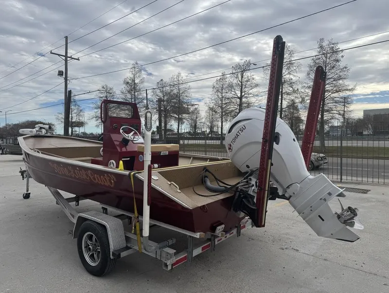 Slide: The Image of 2023 Custom Alumafab 20 CC boat on trailer with Tohatsu outboard motor, parked outdoors. - 12