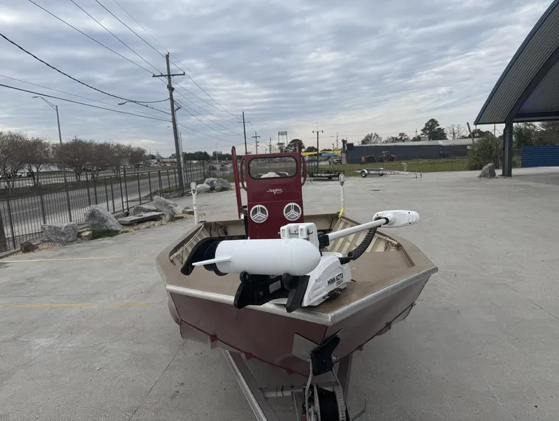Slide: The Image of 2023 Custom Alumafab 20 CC boat with Minn Kota motor on a trailer, overcast sky. - 13