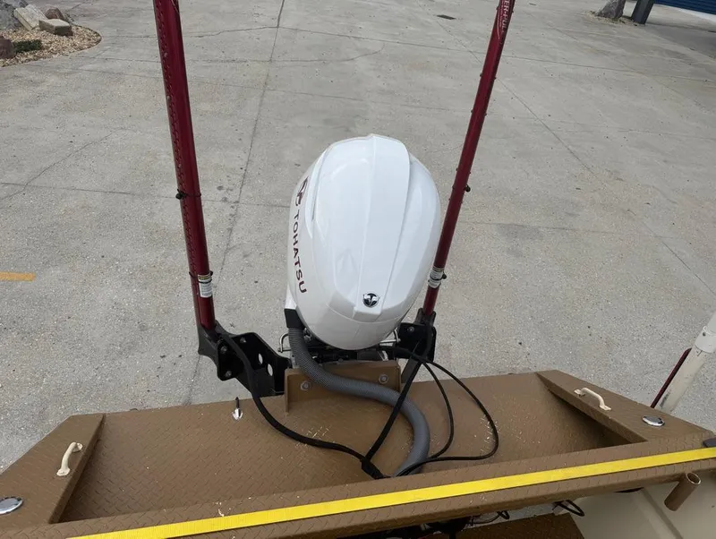 Slide: The Image of 2023 Custom Alumafab 20 CC boat with Tohatsu outboard motor, docked on concrete. - 14