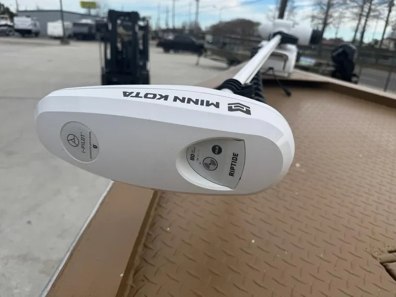 Slide: The Image of Minn Kota Riptide motor on 2023 Custom Alumafab 20 CC boat, outdoor setting. - 7