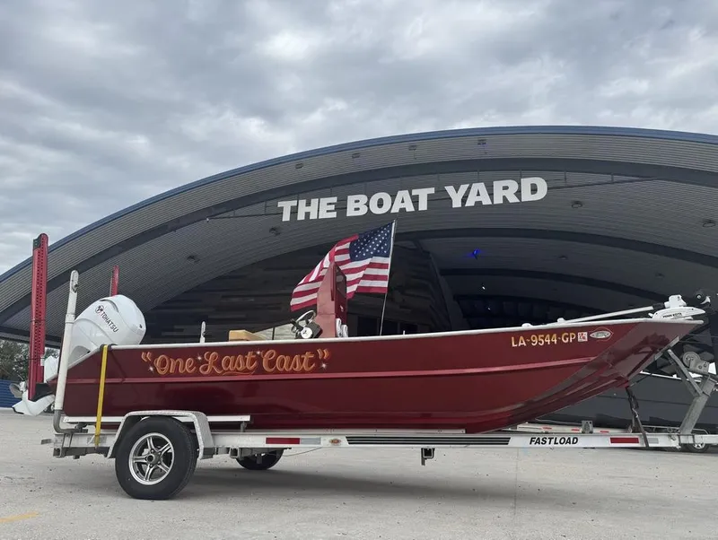 Slide: The Image of 2023 Custom Alumafab 20 CC boat, red with "One Last Cast" text, at The Boat Yard. - 9