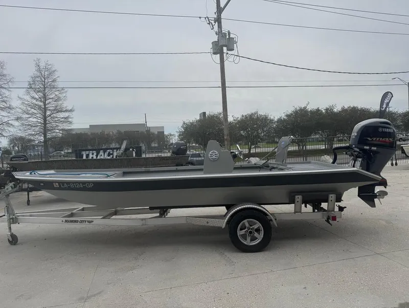 Slide: The Image of 2023 Custom Rene Gros 20 CC boat on trailer, parked outdoors. - 2