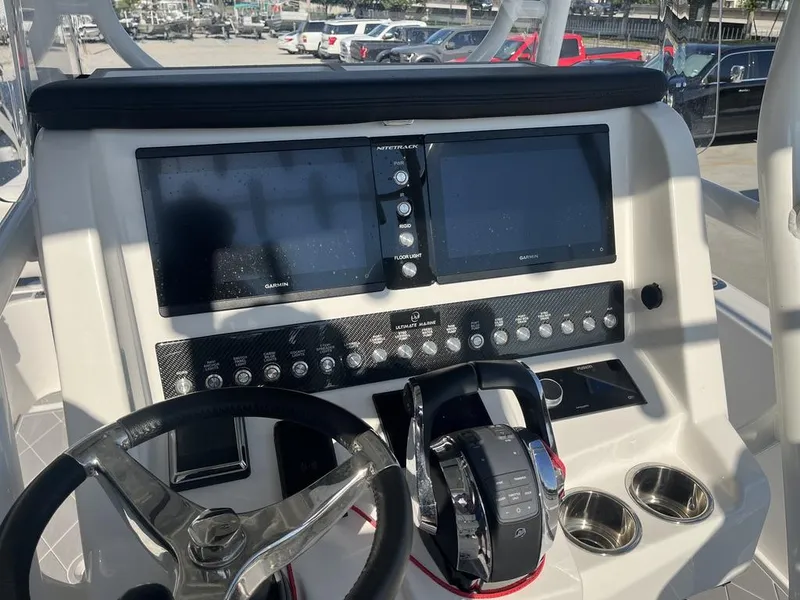 Slide: The Image of 2023 Sea Cat 262 Ultimate Edition boat storage compartment, open with visible contents. - 26