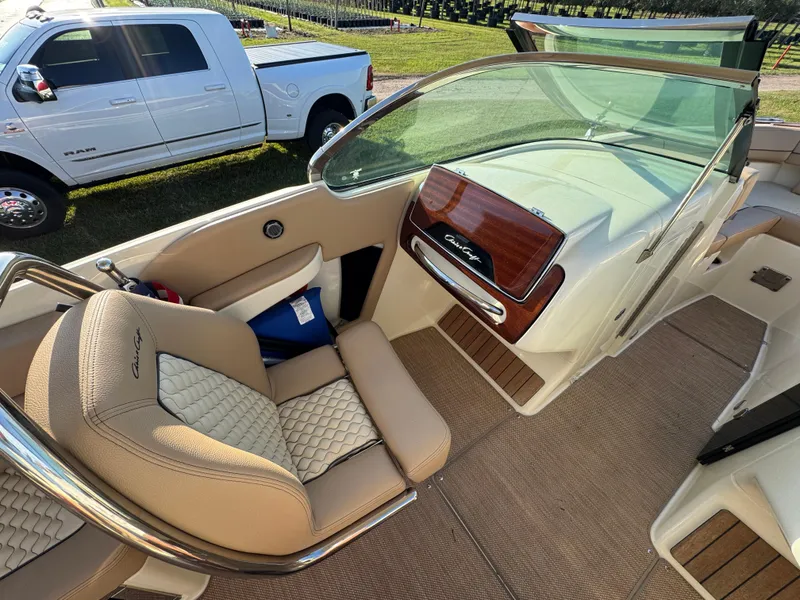 Slide: The Image of 2022 Chris-Craft Launch 25 GT interior with beige seating and wood accents. - 13