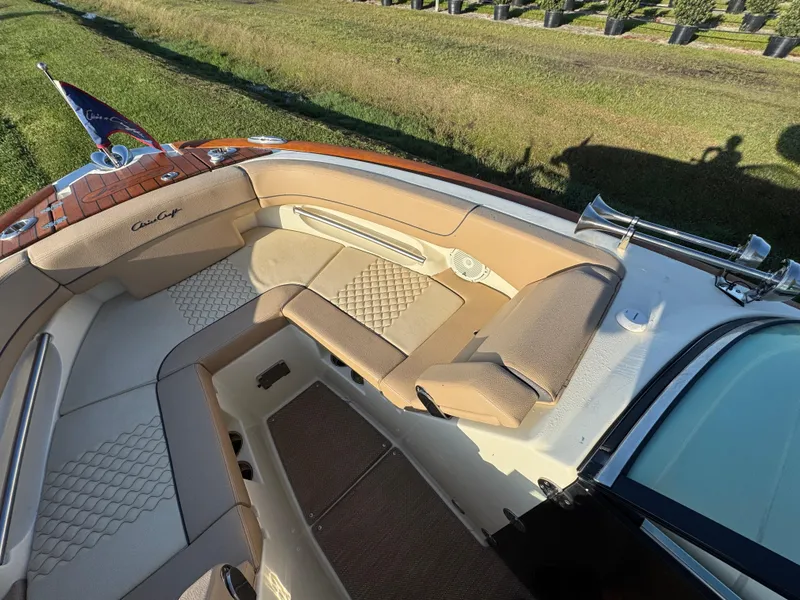 Slide: The Image of Luxurious interior of 2022 Chris-Craft Launch 25 GT boat with elegant seating and wood accents. - 17