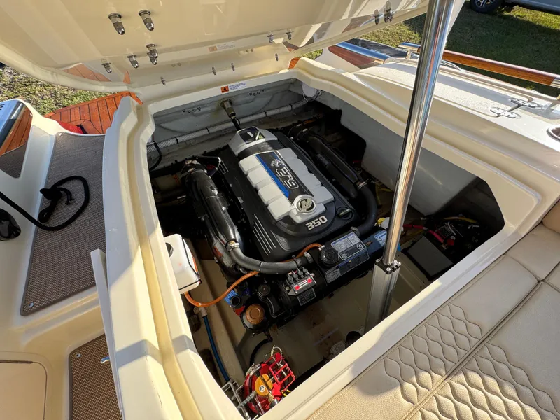 Slide: The Image of 2022 Chris-Craft Launch 25 GT engine compartment showcasing powerful 350 engine. - 21