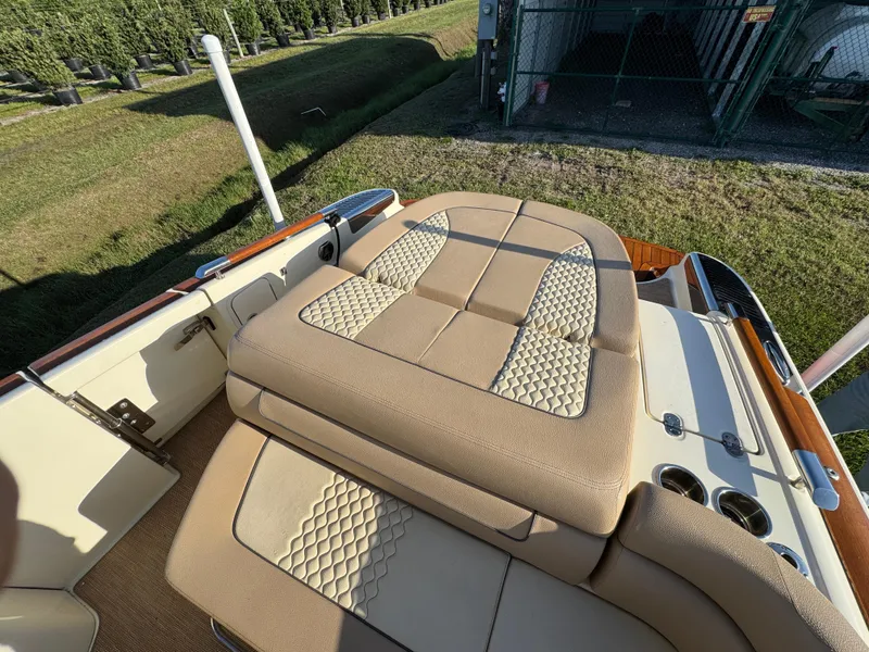 Slide: The Image of 2022 Chris-Craft Launch 25 GT boat with beige seating and elegant design. - 7