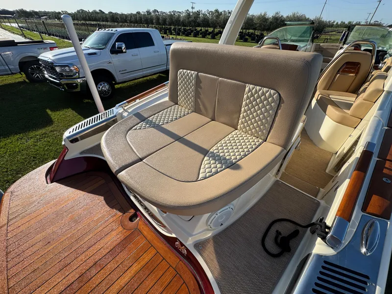 Slide: The Image of 2022 Chris-Craft Launch 25 GT boat with luxurious seating and wooden deck. - 8